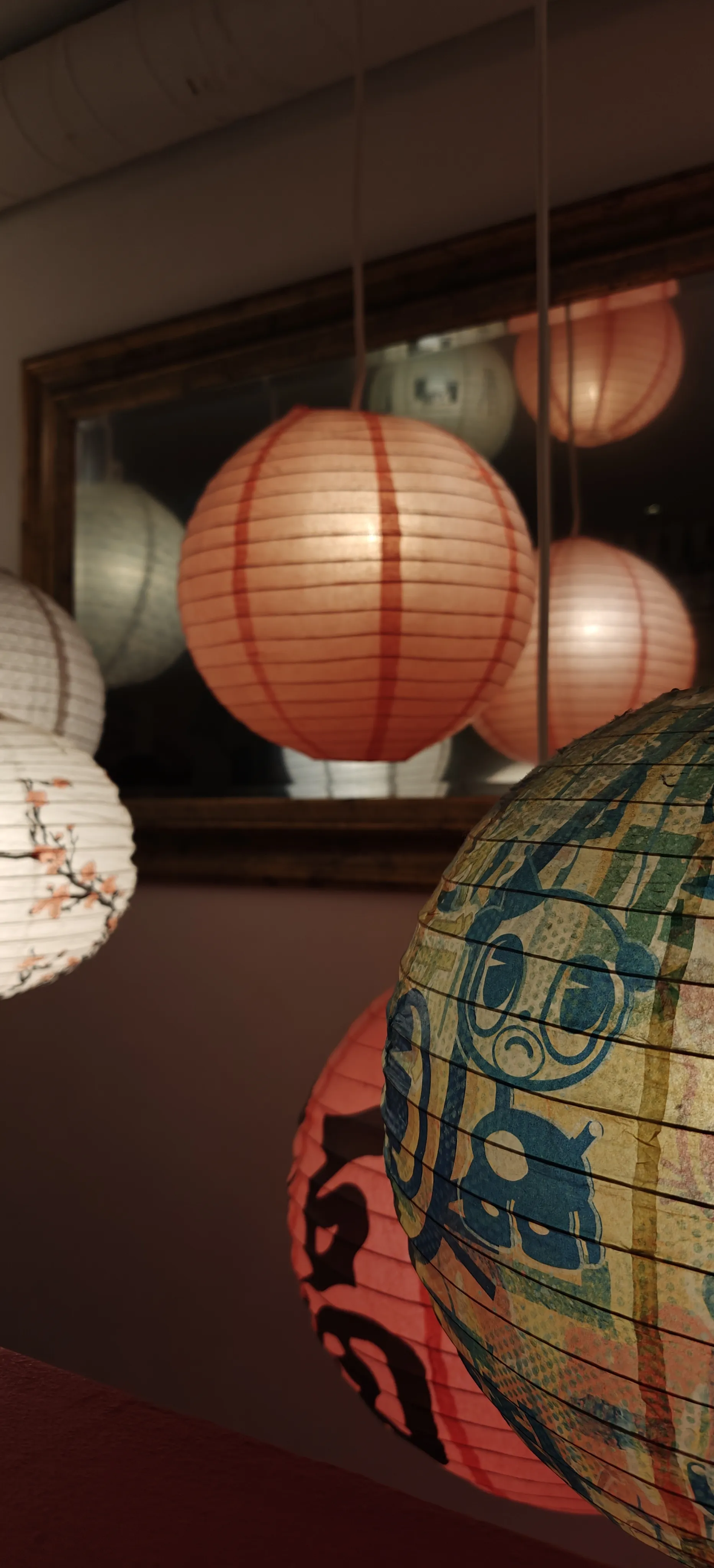 Paper lanterns in front of a mirror