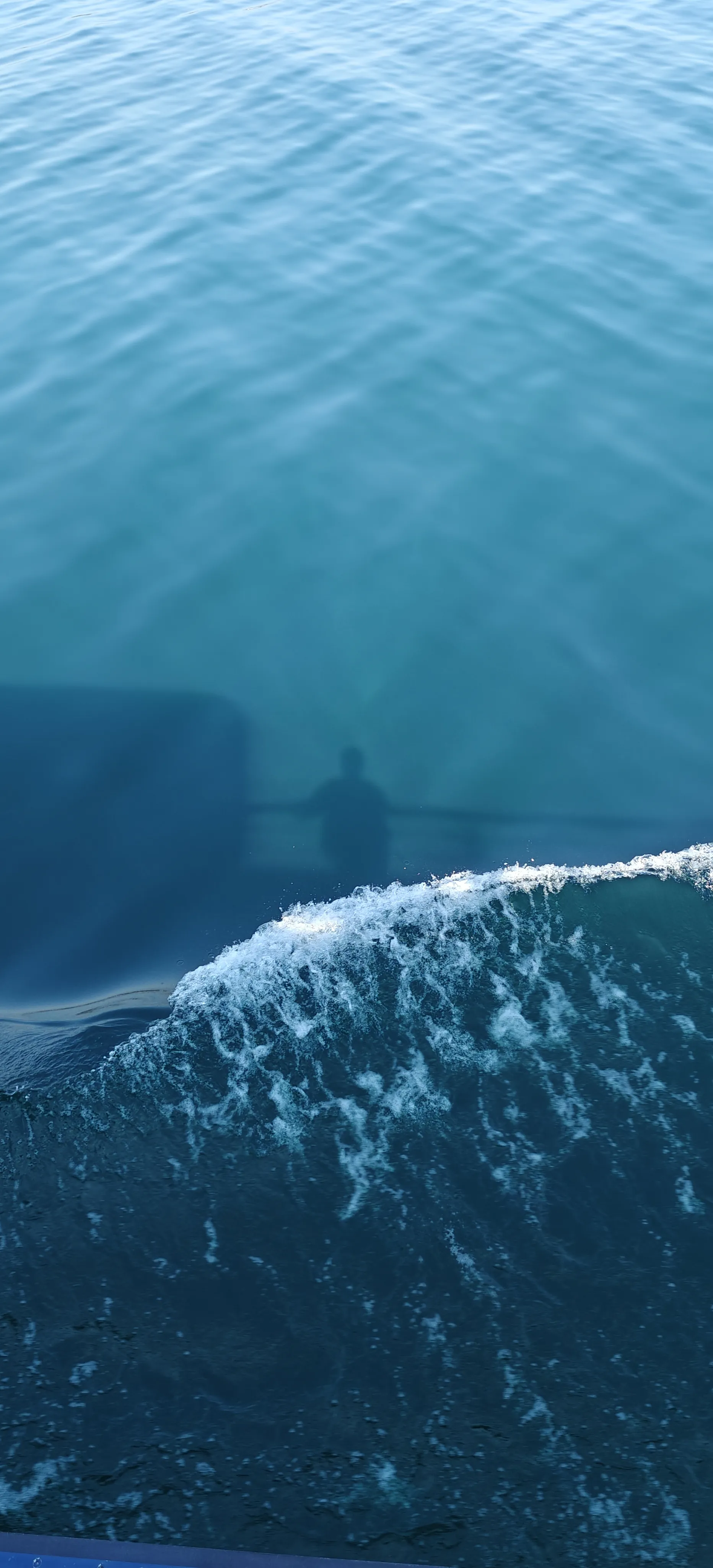 Shadows over a boats wake